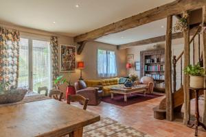 a living room with a couch and a table at La Bastide de Sherlock in Troncens