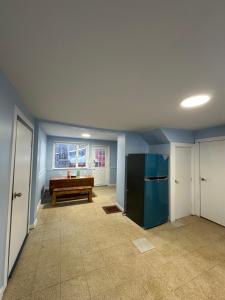 an empty living room with a table and a kitchen at Highway 17 Space Share accommodation in Thessalon