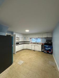 a large kitchen with white cabinets and appliances at Highway 17 Space Share accommodation in Thessalon
