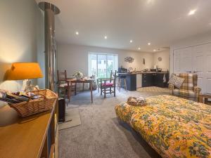 a bedroom with a bed and a kitchen with a table at The Other House in Briston +5 photos