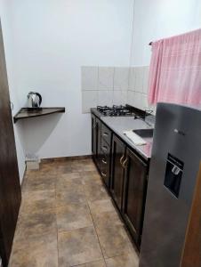a kitchen with a refrigerator and a sink in it at Haus Eldorado in Eldorado +4 photos