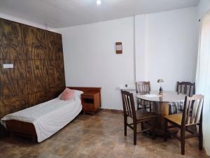 a bedroom with a bed and a table and chairs at Haus Eldorado in Eldorado