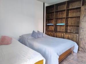 a bedroom with two beds and a closet at Haus Eldorado in Eldorado