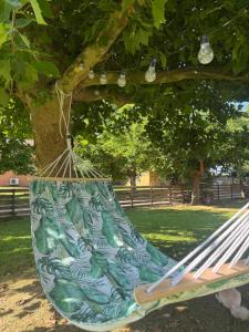 a hammock hanging from a tree in a park at Oasi Loft in Kourouta