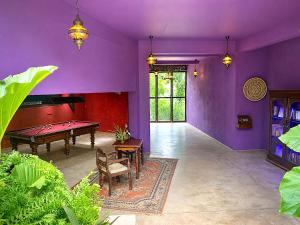 a living room with a pool table and purple walls at Waterland in Negombo