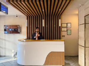 a man standing at a bar with a microphone at THREE TREE Signature Hotel-G7 Markaz Islamabad in Islamabad