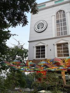 a clock tower with umbrellas in front of a building at THREE TREE Signature Hotel-G7 Markaz Islamabad in Islamabad