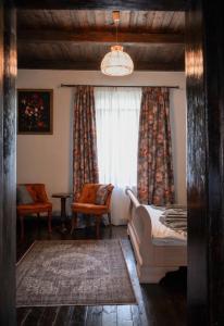 a bedroom with a bed and a window at Casa Huber in Cîrţa +36 photos