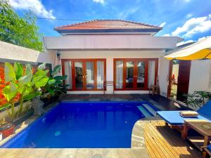 a swimming pool in front of a villa at Mesari Jinah Villa 1 - 2BR Private Pool Near Melasti Beach Uluwatu in Uluwatu