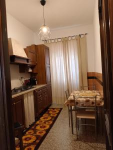 a kitchen with a table and a dining room at Casa Anna in Ladispoli