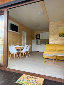 a living room with a yellow couch and chairs at Splav Zoi Perucac in Aluga +16 photos