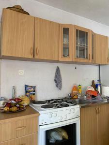 a kitchen with a white stove top oven next to a sink at Drinska oaza in Zvornik