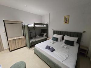 a bedroom with a bed and a bunk bed at Vila Sokrati in Mursi
