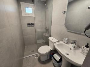 a bathroom with a toilet and a sink and a shower at Vila Sokrati in Mursi +59 photos