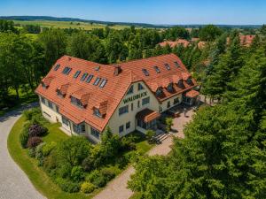 an overhead view of a large house with an orange roof at Hotel & Restaurant Waldblick in Pulsnitz
