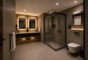 a bathroom with a shower and a toilet and a sink at T h e V o i d Hotel - Just Steps From Osmanbey Metro Station in Esenyurt +16 photos