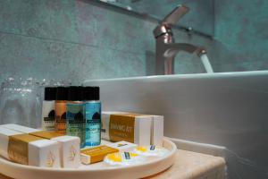 a bathroom counter with toiletries and a sink at Omar Khayyam Hotel in Bukhara +50 photos