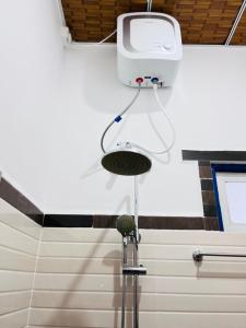 a shower in a bathroom with a camera on the wall at Harsha Villa Dickwella in Dickwella