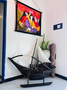 a black hammock in a room with a painting on the wall at Harsha Villa Dickwella in Dickwella
