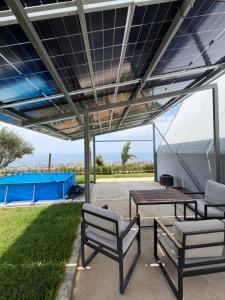 a patio with a table and two chairs and a picnic table at Moobs Sunset Cabins in Batroûn +5 photos