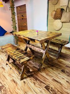 a wooden picnic table and benches in a room at Harsha Villa Dickwella in Dickwella +7 photos