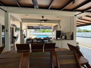 a dining room and living room with a table and chairs at Untung5tay in Gua Sai