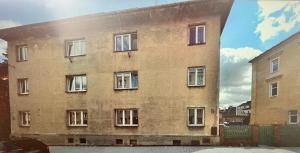 a large brick building with many windows at Máneska in Cheb