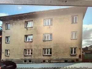 a large brick building with many windows at Máneska in Cheb +2 photos