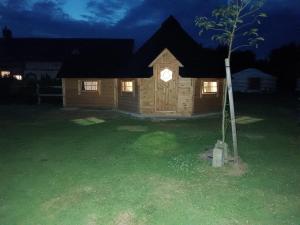 a log cabin at night with a tree in the yard at Rando-Yourte in Paluel +37 photos