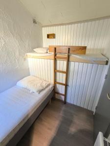 a small bedroom with two bunk beds in it at Bungalows du Lac de Rabais in Virton