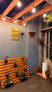 a wooden bench with potted plants on a wall at Serra Charm House in Ubajara