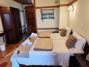 a bedroom with two beds with towels on them at Prespa Resort & Spa in Platy +75 photos