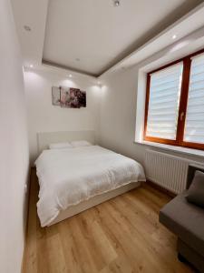 a bedroom with a white bed and a window at L&S House in Prague +12 photos