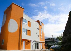 a building with an orange and white at Yang Yang Timi House Pension in Yangyang