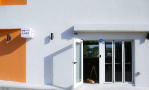 a dog laying in the doorway of a building at Yang Yang Timi House Pension in Yangyang