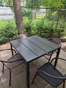 a black picnic table and two chairs on a patio at The Loka in Riga