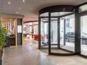 a lobby with a revolving door in a store at Ibis Brussels City Centre in Brussels