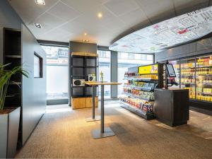 a grocery store with a table in the middle at Ibis Brussels City Centre in Brussels