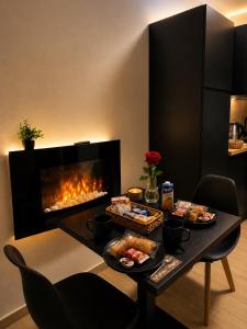a table with food and a fireplace in a room at Seven Suite SPA in Fiumicino +8 photos