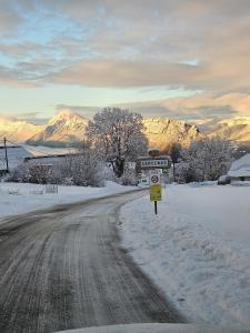 a snow covered road with a no parking sign on it at Le chalet chartreux in Sarcenas