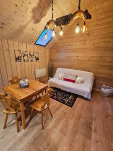 a bedroom with a bed and a table in a room at Le chalet chartreux in Sarcenas