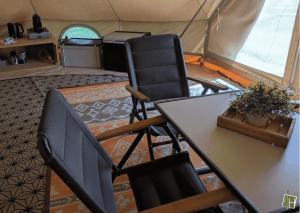 a table and two chairs in a tent at Camping Houtum in Kasterlee