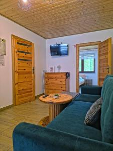 a living room with a couch and a table at Leśny Dwór Bieszczady in Ustrzyki Dolne