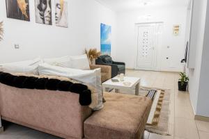 a living room with two couches and a table at Vila Goxhaj in Sarandë
