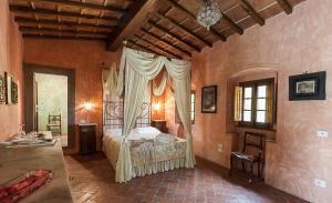 a bedroom with a bed with a canopy at Villa Il Paradisino in Sesto Fiorentino