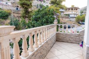 a balcony of a house with a white railing at Vila Goxhaj in Sarandë