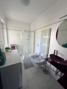 a white bathroom with a sink and a toilet at DreamLiving Vasto Panorama in Vasto