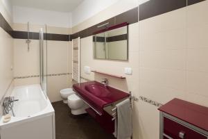 a bathroom with a red sink and a toilet at DreamLiving Vasto Panorama in Vasto