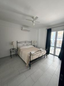 a bedroom with a bed and a ceiling fan at DreamLiving Vasto Panorama in Vasto