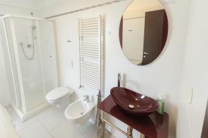 a bathroom with a sink and a toilet and a mirror at DreamLiving Vasto Panorama in Vasto
